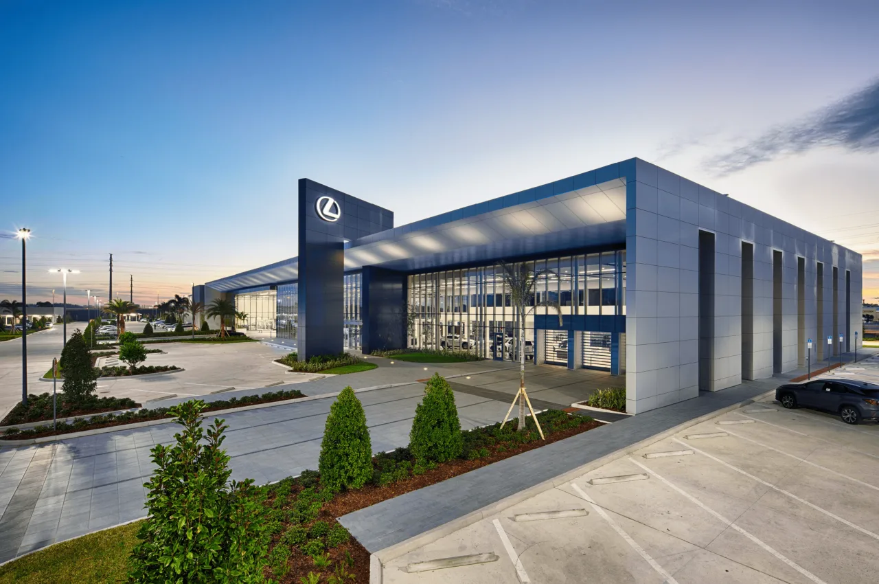 Lexus dealership architecture at dusk, showing the glazed showroom, entrance and landscape