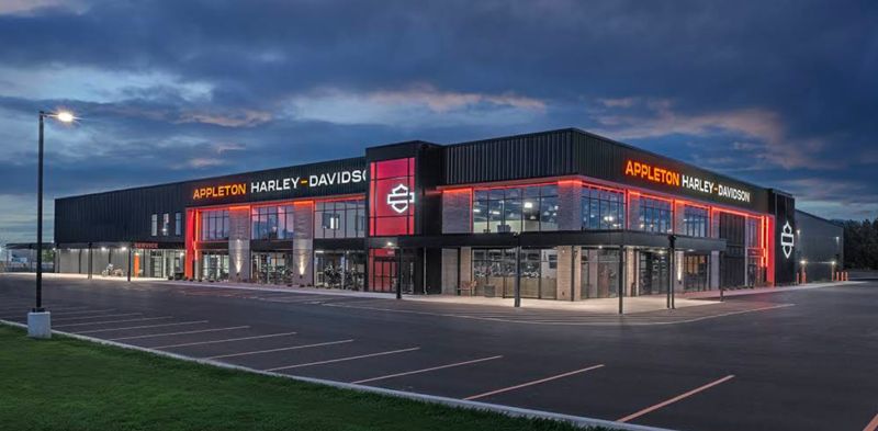 Appleton Harley-Davidson dealership exterior at dusk, with illuminated facade and brand signage