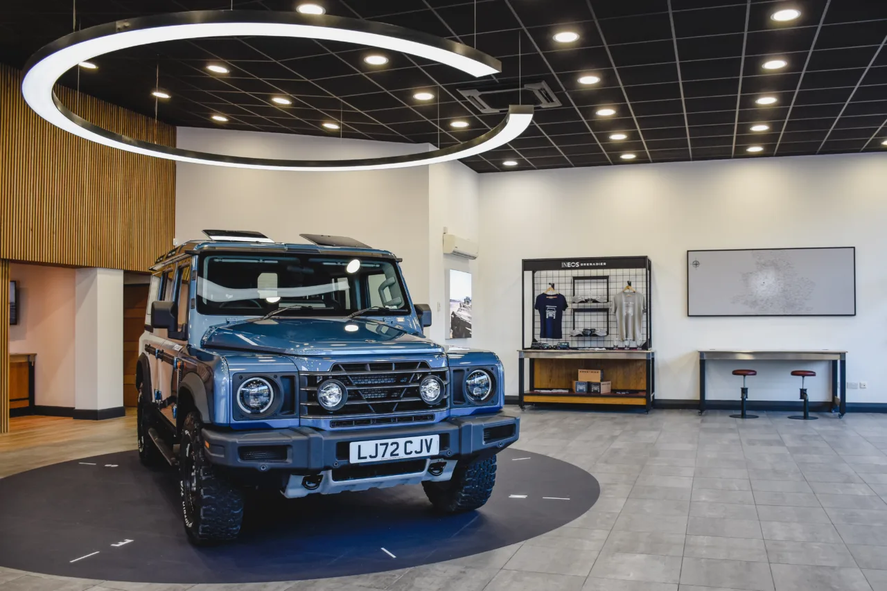 INEOS Grenadier showroom with a vehicle beneath circular display lighting